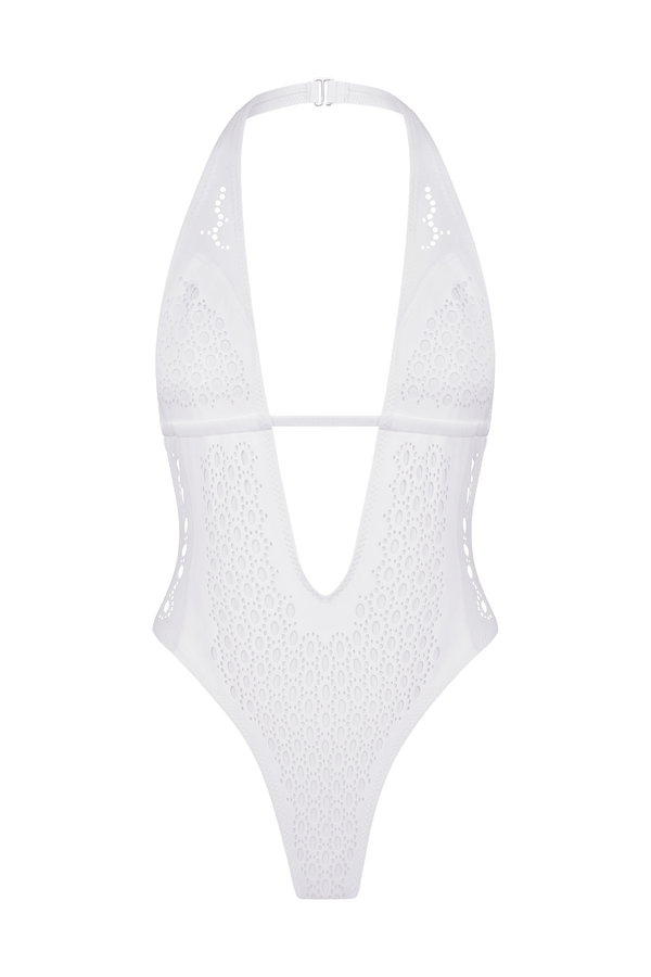 The Camilla One Piece by Gigi C Bikinis is a white swimsuit, featuring a deep V-neck and halter strap. Its laser cutouts and textured circular pattern give it a modern twist and sleek, minimalist aesthetic.