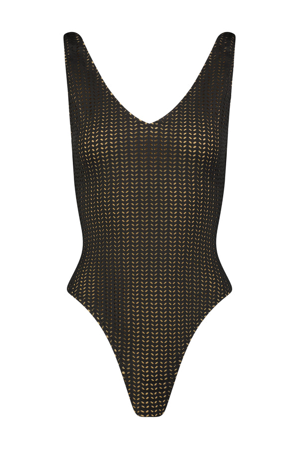 The Haven One-Piece by Gigi C Bikinis is a sleek black mesh bodysuit with a deep V-neck and high-cut legs. Made from chevron scuba fabric, it features a woven pattern with beige underlay for contrast and is sleeveless, displayed against a plain white background for effortless style.