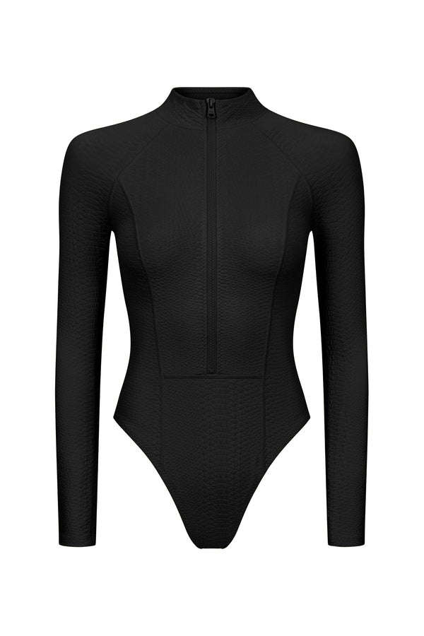 This modern black bodysuit, reminiscent of the Sophie Surfsuit by Gigi C Bikinis, features a sleek long-sleeved design with snakeskin embossed fabric, high neckline, and front zipper, perfect for water sports.